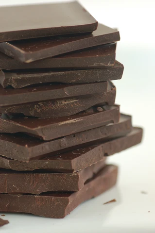 Cannabis edible chocolate infused with cannabis made with organic cacao powder and organic cacao butter stacked on top of each other in front of a plain white background made for healthy lifestyles